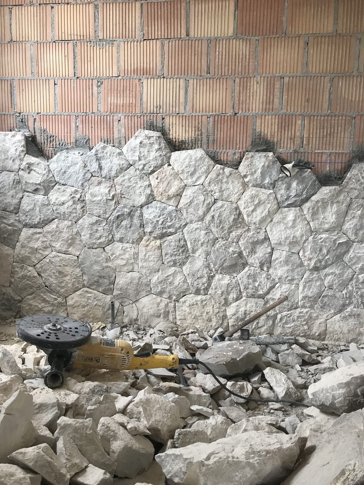 Instalación de piedra natural en fachada, en proceso